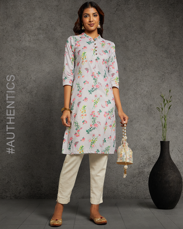 Stylish Grey Floral Hand Block Cotton V-Neck Kurta, paired with off white pant and jutti, worn by a woman standing next to a flowerpot.