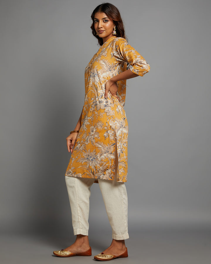 Side profile of a Yellow Collar Neck Hand Block Cotton Kurti with three-quarter sleeve paired with white pant  , showcasing the kurti's length and the smooth drape over the body