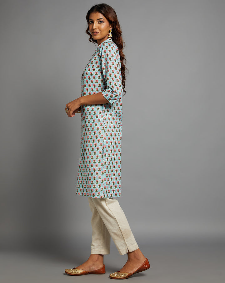 Side profile of a Sky Blue Floral Hand Block Cotton Kurti with three-quarter sleeve paired with white pant  , showcasing the kurti's length and the smooth drape over the body