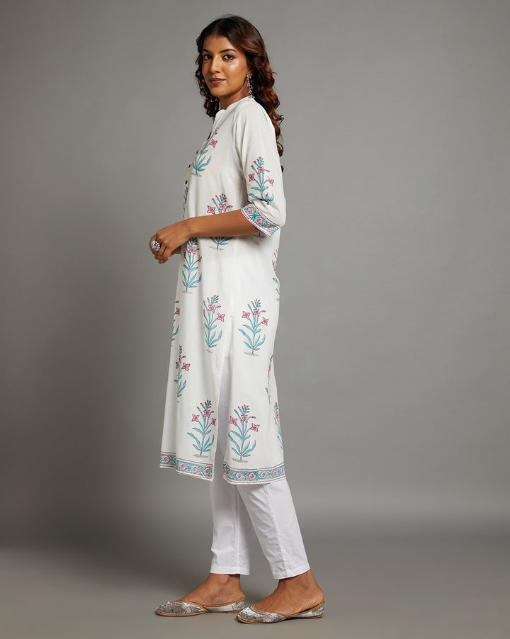 Side profile of a  white Kurti with Jaipuri floral print paired with white pant and jutti, showcasing the kurti's length and the smooth drape over the body