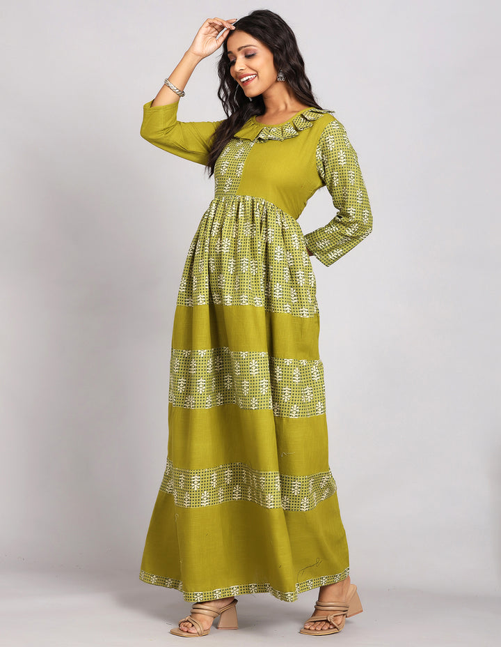 Side profile of a Printed Mehndi Green with Round Neck Long Kurti with three-fourth sleeves paired with brown sandals, showcasing the kurti's length and the smooth drape over the body