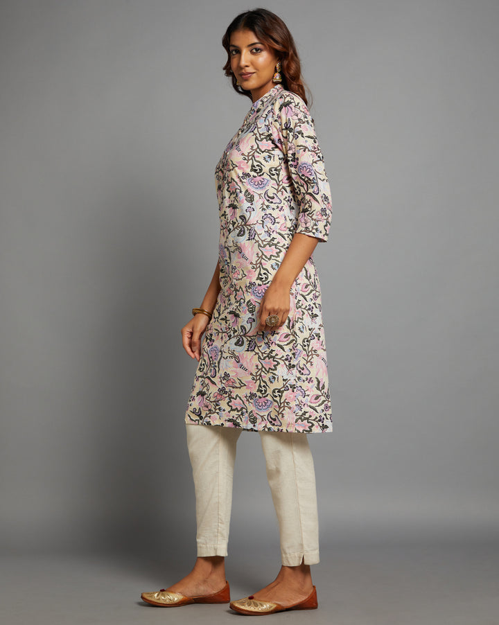 Side profile of a Pastel Yellow Floral Hand Block Cotton V-Neck Kurta with three-quarter sleeve paired with white pant, showcasing the kurti's length and the smooth drape over the body