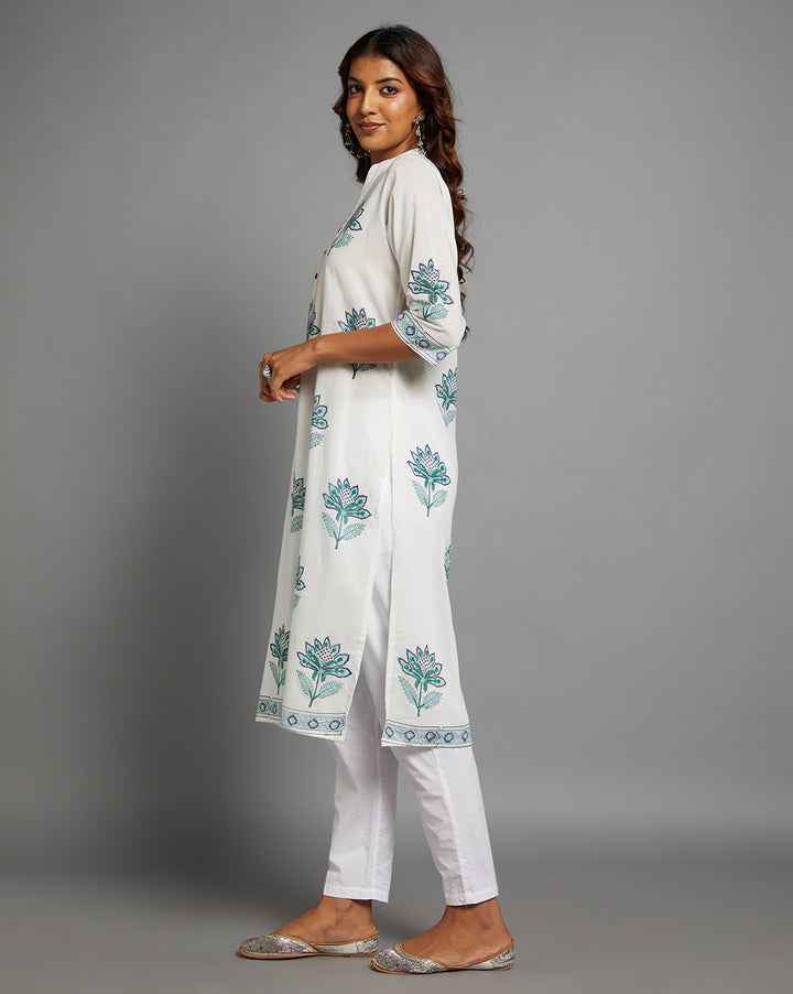 Side profile of a woman wearing White Cotton Straight Kurta with Chinese Collar and V-Neck with three-quarter sleeve paired with white pant and jutti, showcasing the kurti's length and the smooth drape over the body