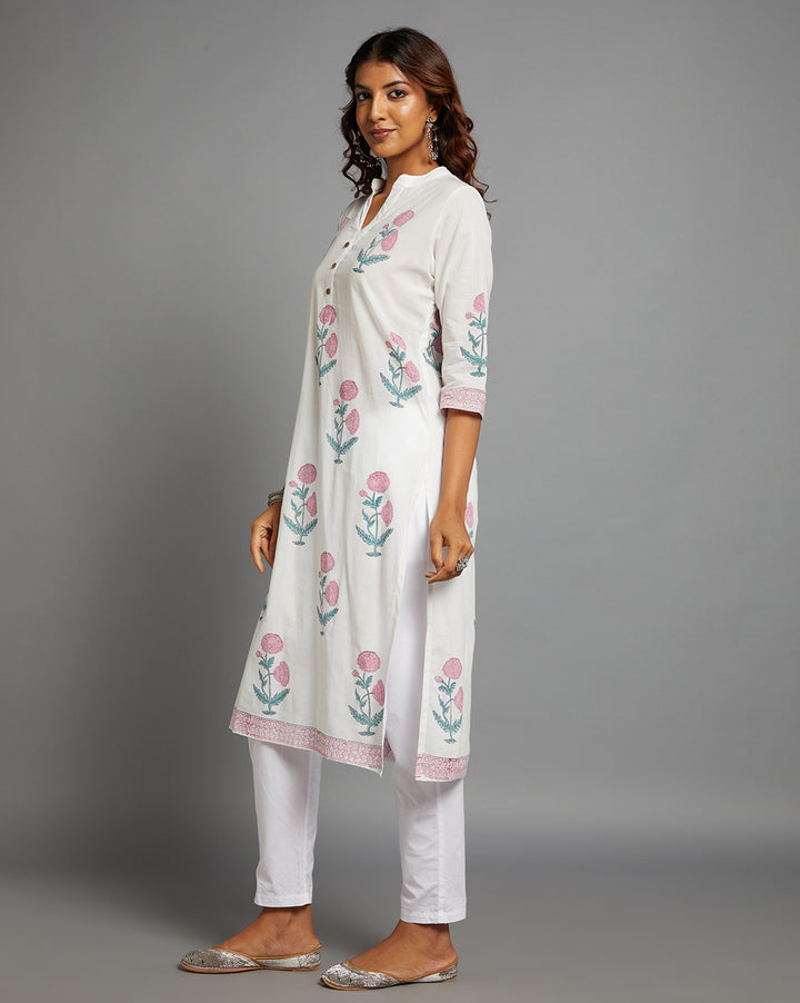 Side profile of a White V Neck Hand Block Cotton Kurti with three-quarter sleeve paired with white pant, showcasing the kurti's length and the smooth drape over the body