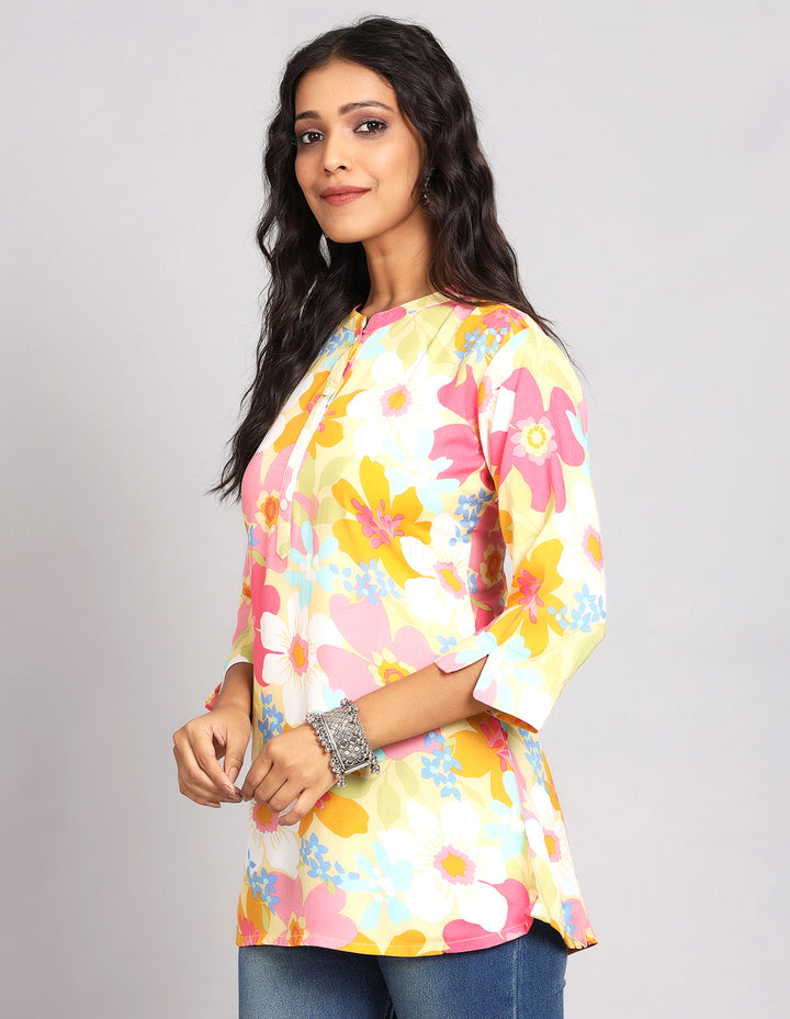 Side profile of a woman wearinga  Multicolor Short Kurti with Collar Neck Line with three-quarter sleeve paired with Blue skinny jeans and brown sandals, showcasing the kurti's length and the smooth drape over the body