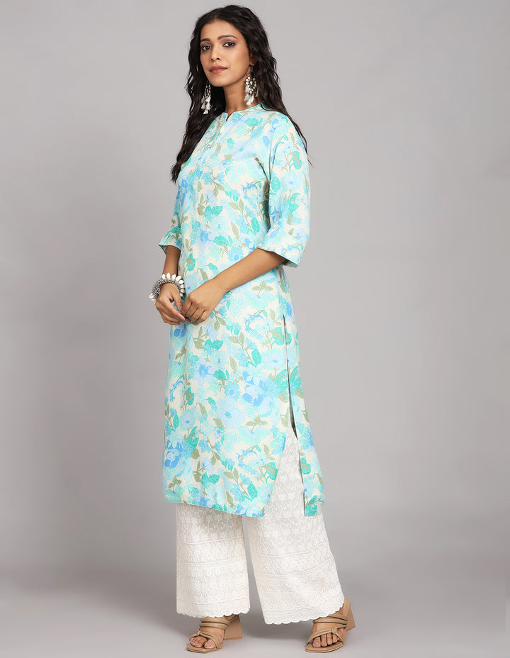 Side profile of a Blue color Long Kurti with collar Neck design with three-quarter sleeve paired with white palazzo and brown sandals, showcasing the kurti's length and the smooth drape over the body