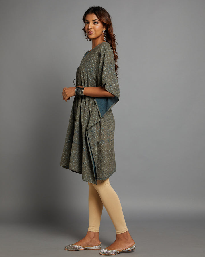 Side profile of a woman wearing a Grey V-Neck Hand Block Print Cotton Kaftan, paired with skin color legging and half sleeve, showcasing the kurti's length and the smooth drape over the body