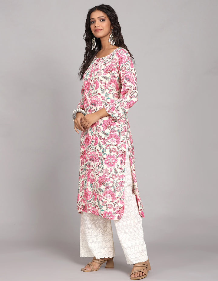 Side profile of a woman wearing a white floral printed long kurti with three-quarter sleeves  and white wide leg palazzo, showcasing the kurti's length and the smooth drape over the body