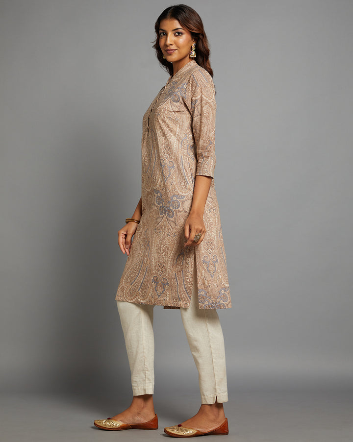 Side profile of a Brown Floral Hand Block Cotton V-Neck Kurti with three-quarter sleeve paired with white pant, showcasing the kurti's length and the smooth drape over the body