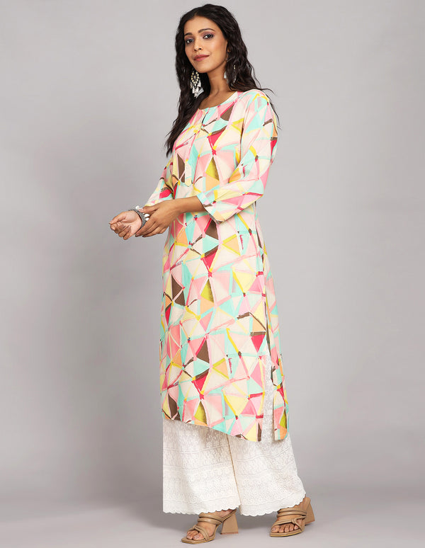 Stylish Multicolor Printed Long Kurti with Round Neck Design, paired with white palazzo and brown heels, worn by a woman standing in white background with open hair.