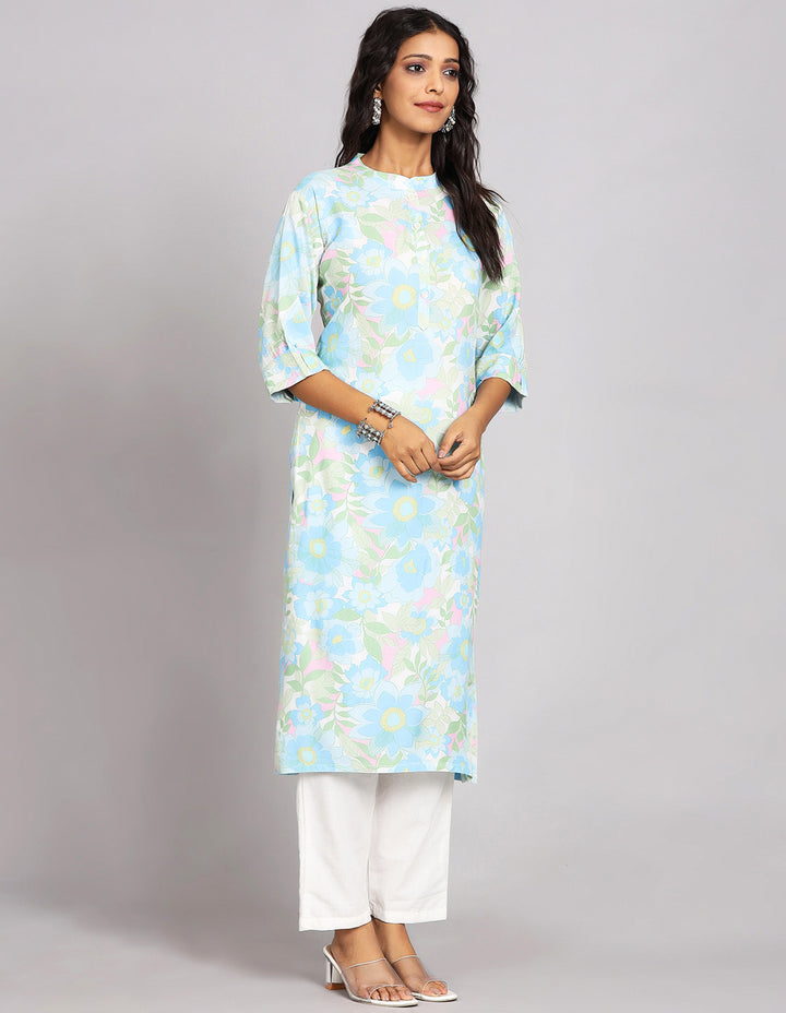 Side profile of a Sky Blue Long Kurti with Collar Neck Line and three fourth sleeves with white pant and transparent sandals, showcasing the kurti's length and the smooth drape over the body