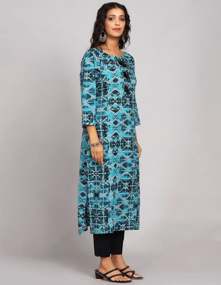 Side profile of a  Printed Blue Cotton Kurti paired with black pant and black heels, showcasing the kurti's length and the smooth drape over the body