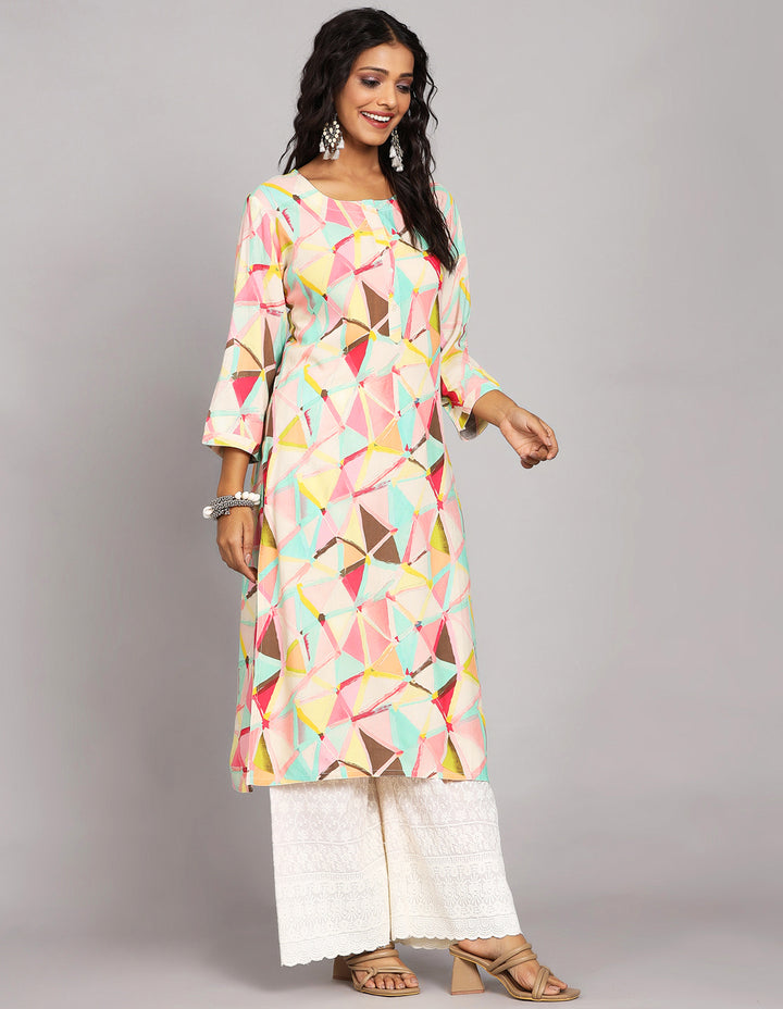 Side profile of a  Multicolor Printed Long Kurti with Round Neck Design with three-quarter sleeve paired with white palazzo and brown sandals, showcasing the kurti's length and the smooth drape over the body.