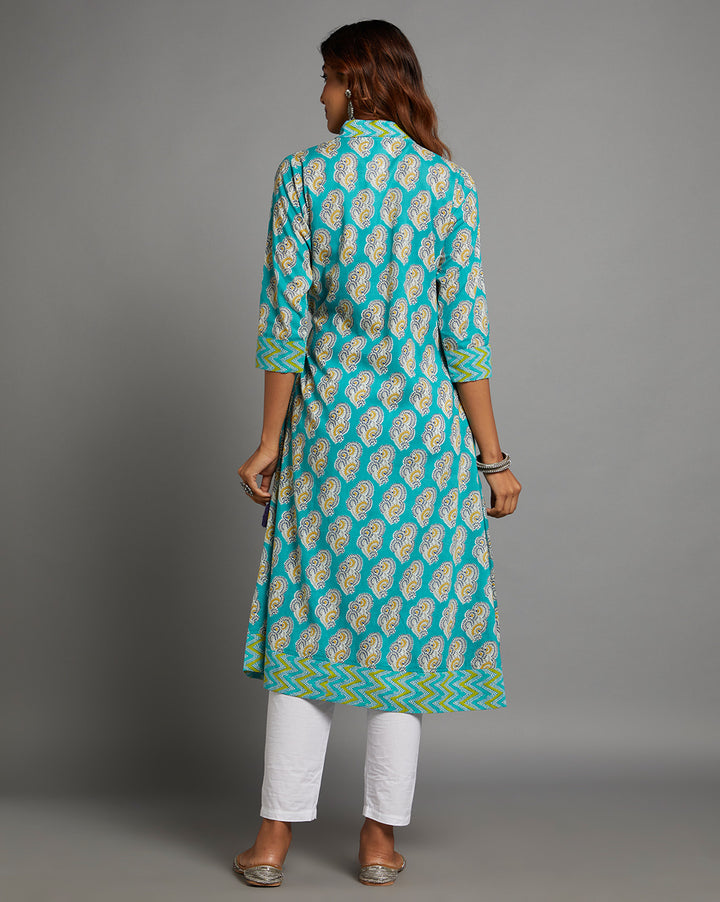 Woman showing the back view of blue angrakha kurta with  V-Neck with three-quarter sleeve paired with white pant and jutti, highlighting the relaxed fit and simple design from behind.
