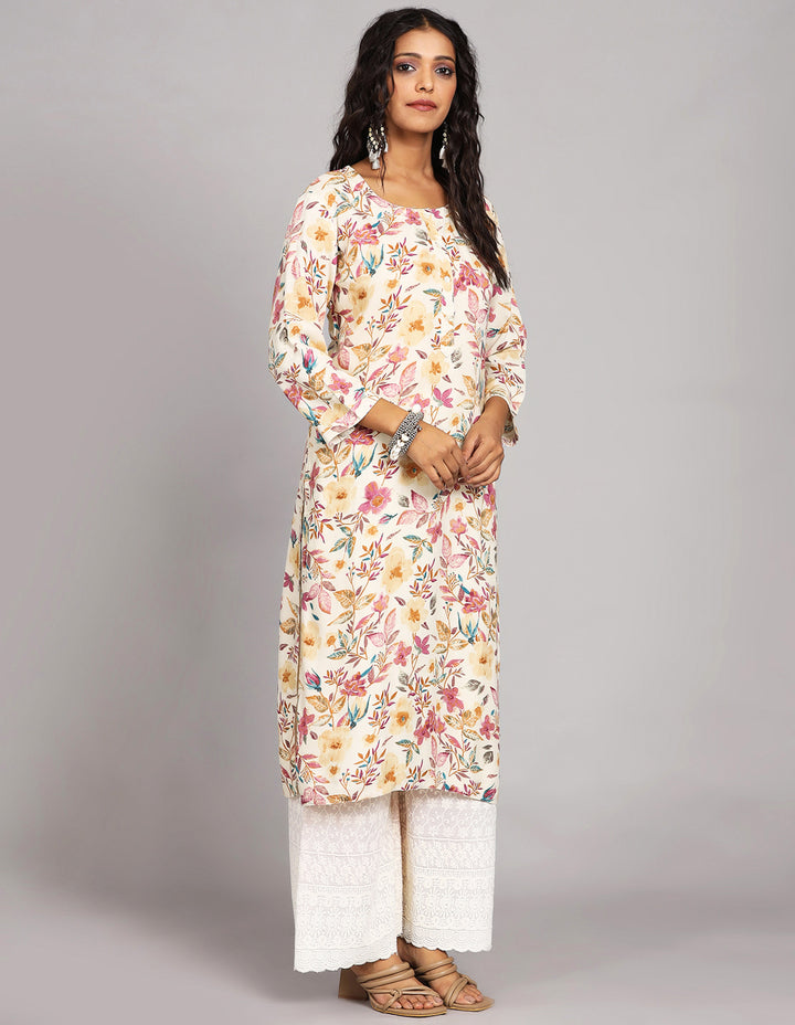 Side profile of a  Cream Yellow Floral Printed Long Kurti with Round Neck Design with three-quarter sleeve paired with white palazzo and brown sandals, showcasing the kurti's length and the smooth drape over the body