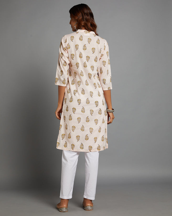 Woman showing the back view of Baby pink straight kurta  knee length and three-fourth sleeves paired with white pant and silver jutti, highlighting the relaxed fit and simple design from behind.
