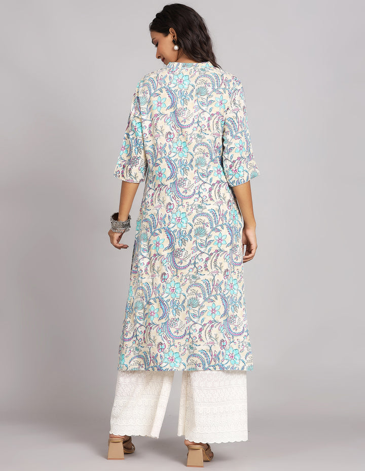 Woman showing the back view of a cream three-quarter sleeve long kurti paired with wide leg palazzo, highlighting the relaxed fit and simple design from behind.