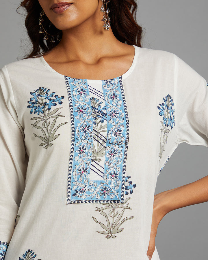 Close-up view of White Round Neck Hand Block Cotton Kurti, focusing on the fabric texture,Wodden Buttons, neckline and stitching details.
