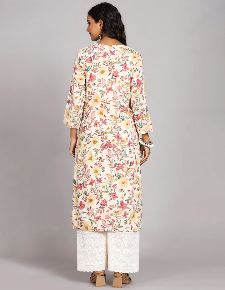 Woman showing the back view of a  Cream Yellow Floral Printed Long Kurti with Round Neck Design and three-quarter sleeve, paired with white palazzo and brown heels, highlighting the relaxed fit and simple design from behind.