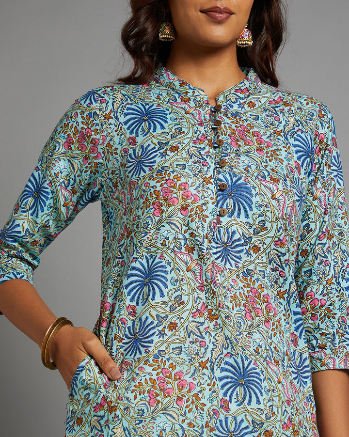 Close-up view of Sky blue floral printed kurta, focusing on the fabric texture, neckline, wooden buttons and stitching details.
