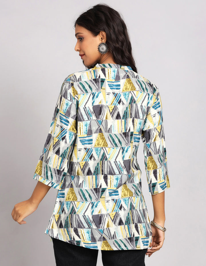 Woman showing the back view of a Printed Grey color Short Kurti with slited three-quarter sleeve paired with black jeans and brown slipeers, highlighting the relaxed fit and simple design from behind.