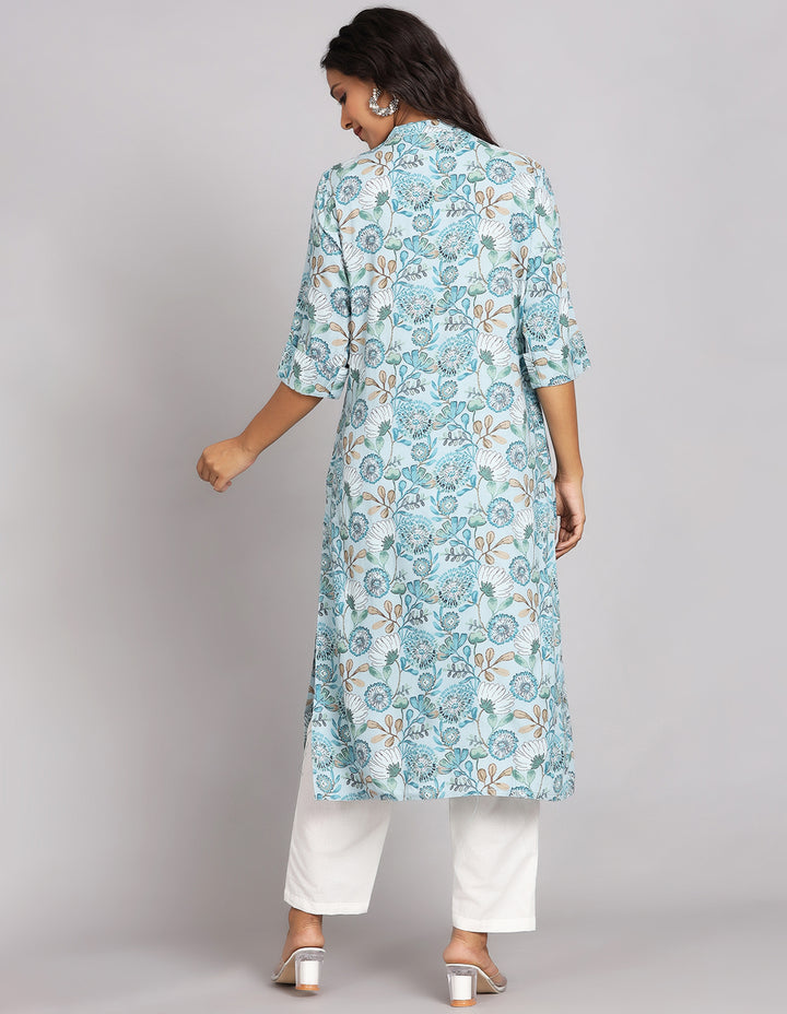 Woman showing the back view of Blue and Grey color Long Kurti with Collar Neck Line with white pant and white transparent sandals, highlighting the relaxed fit and simple design from behind.