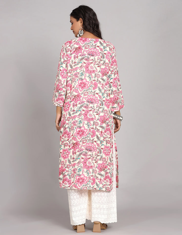 Woman showing the back view of a white floral printed three-quarter sleeve long kurti paired with wide leg palazzo, highlighting the relaxed fit and simple design from behind.