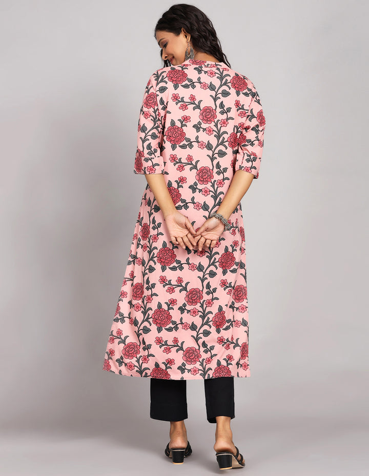 Woman showing the back view of a Pink Color Floral Print Long Kurti with collar Neck design with black pant and black sandals, highlighting the relaxed fit and simple design from behind.