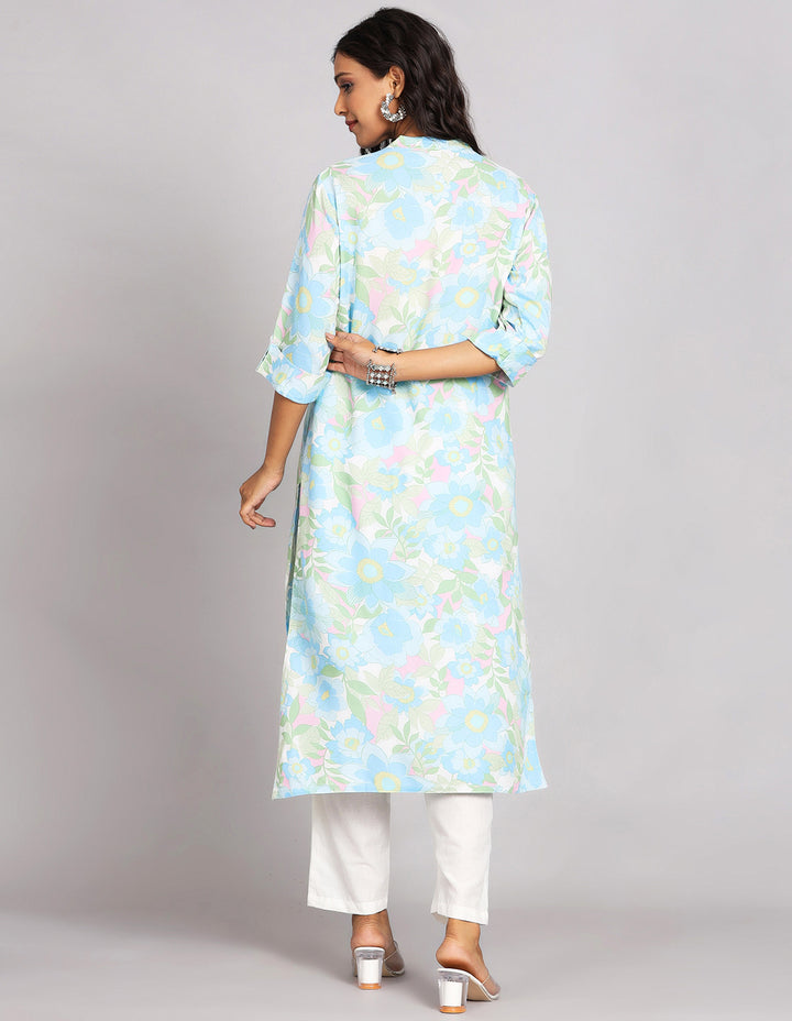 Woman showing the back view of  Sky Blue Long Kurti with Collar Neck Line with white pant and white transparent sandals, highlighting the relaxed fit and simple design from behind.
