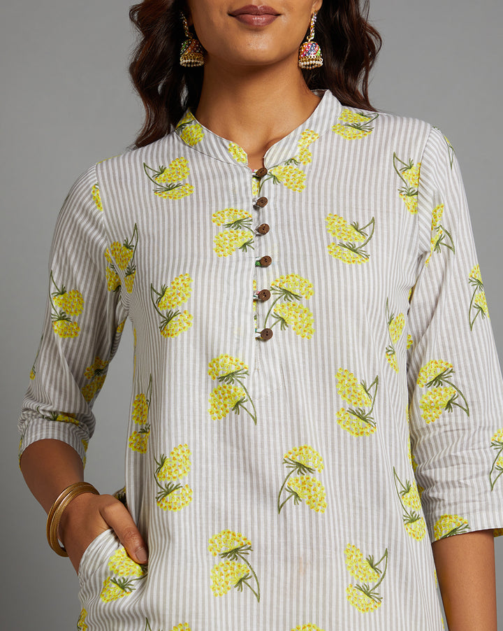 Close-up view of Sunny Yellow Floral Hand Block Cotton V-Neck Kurta, focusing on the fabric texture, wooden buttons, neckline and stitching details.