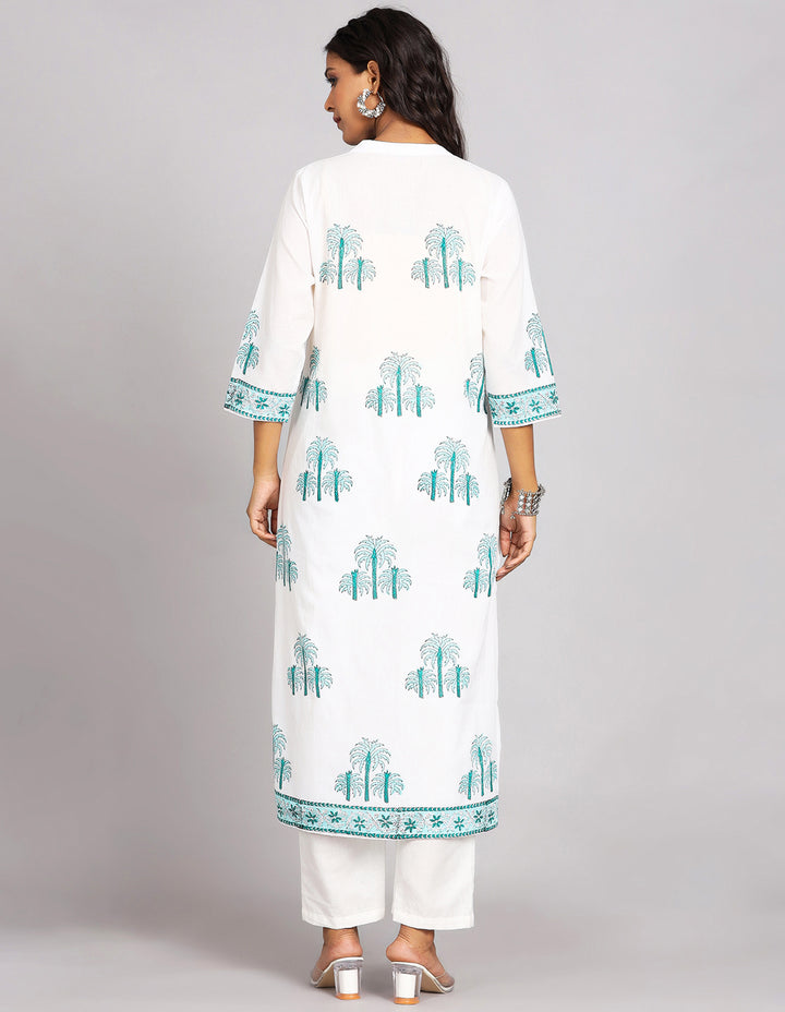 Woman showing the back view of White Long Kurti With Hand Block Print with white pant and white transparent sandals, highlighting the relaxed fit and simple design from behind.
