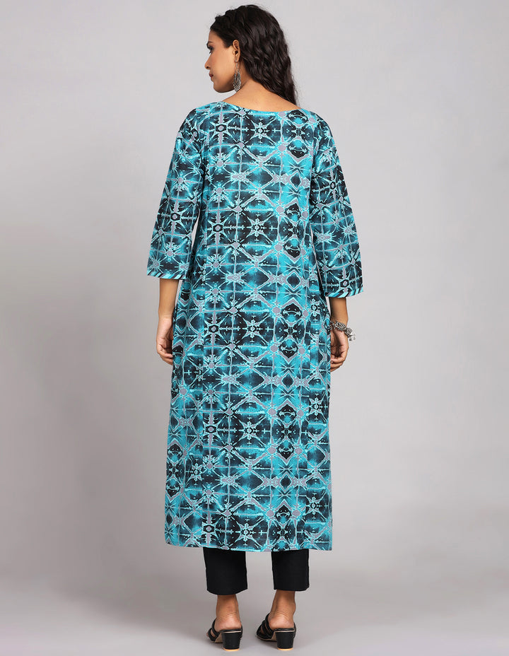  Printed Blue Cotton Kurti with three-fourth sleeves paired with black pant and black sandals, highlighting the relaxed fit and simple design from behind.