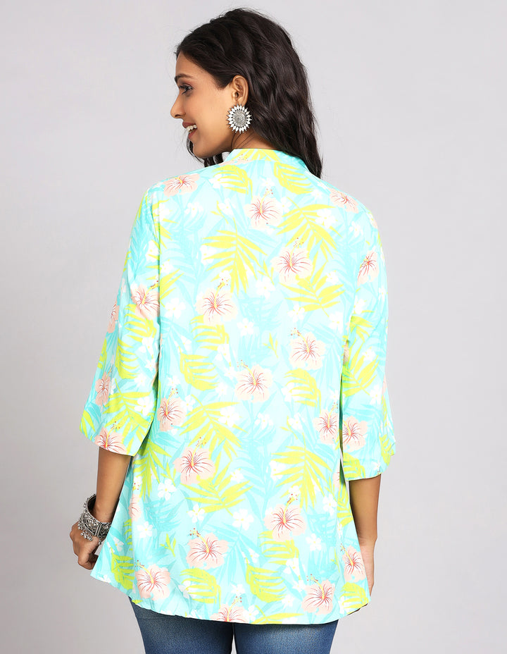 Woman showing the back view of Sky Blue Short Kurti with three-quarter sleeve paired with blue skinny jeans and brown sandals highlighting the relaxed fit and simple design from behind.