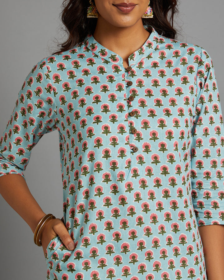 Close-up view of Sky Blue Floral Hand Block Cotton Kurta, focusing on the fabric texture,Wooden Buttons, neckline and stitching details.
