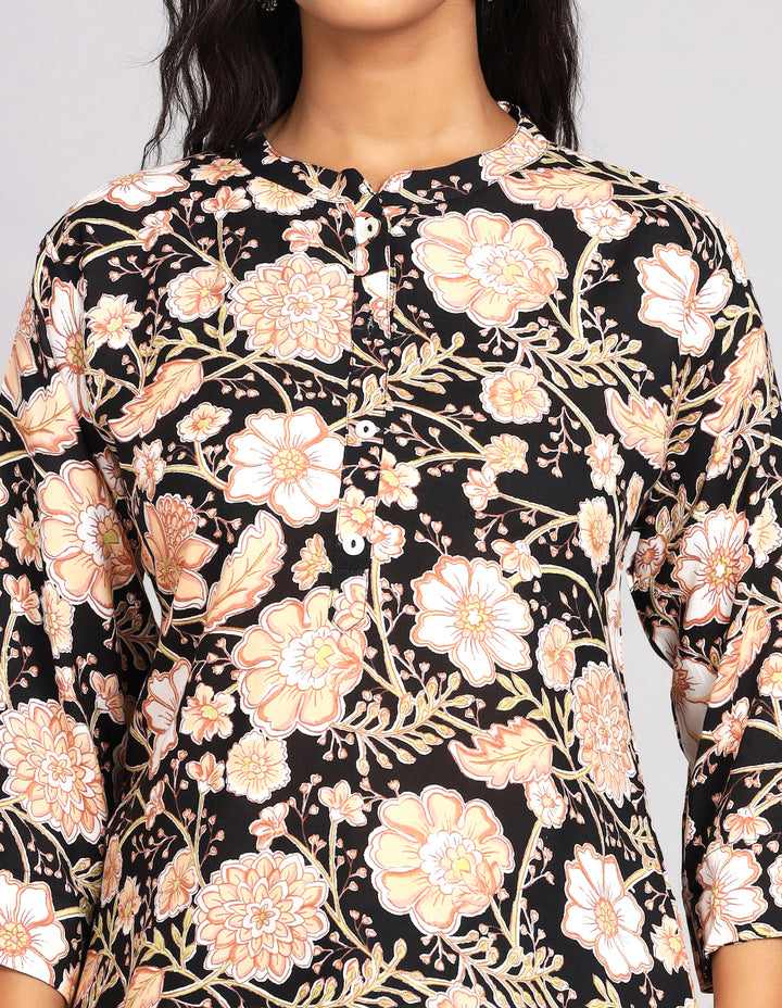 Close-up view of a floral print black Kurti, focusing on the fabric texture, neckline and stitching details.