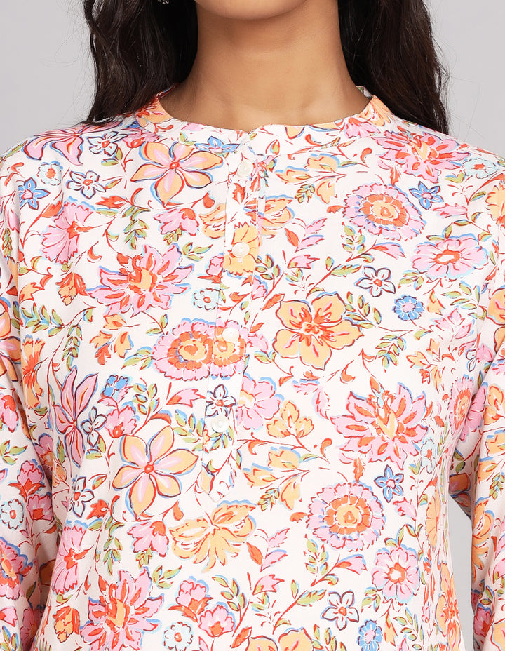  Close-up view of a Floral Cream color Short Kurti, focusing on the fabric texture, neckline, buttons and stitching details.