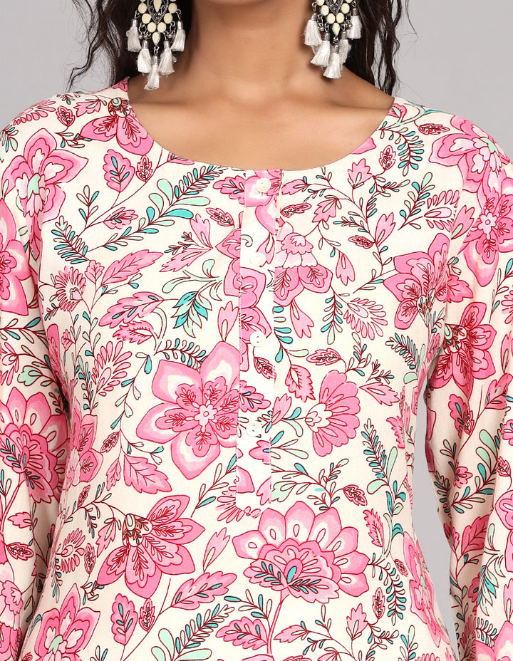 Close-up view of a white long kurti with floral print, focusing on the fabric texture, neckline, and stitching details.