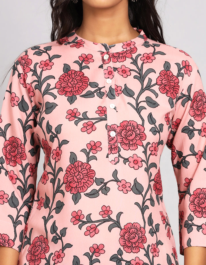 Close-up view of  Chalk Pink floral printed Short Kurti, focusing on the fabric texture, buttons, and stitching details.