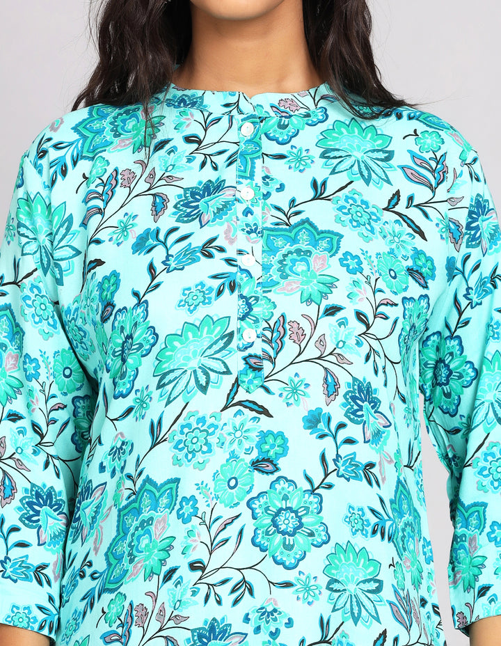 Close-up view of  Aqua Green Short Kurti with Floral Print , focusing on the fabric texture, neckline and stitching details.