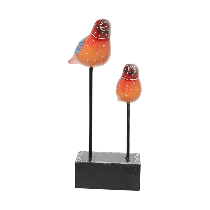 bird pair figurine placed at iron rod table decor