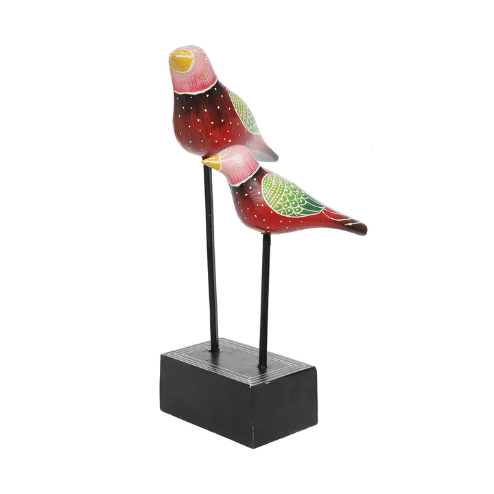 wooden bird pair figurine placed at iron rod