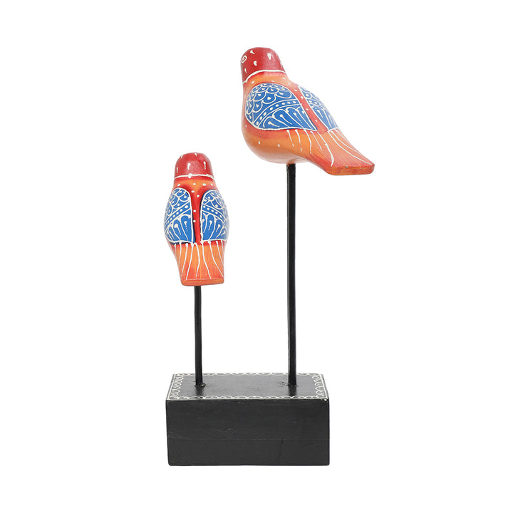 hand-painted bird pair figurine placed at iron rod